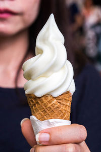 Close-up of hand holding ice cream cone