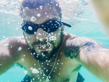 Portrait of man swimming in sea