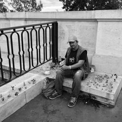 Portrait of man sitting amidst toys