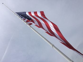 Low angle view of american flag against sky