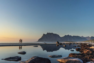 Scenic view of sea against clear sky at sunset