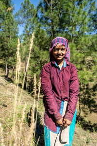 Portrait of smiling woman standing on land