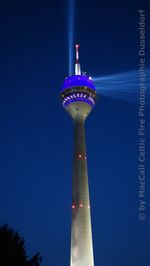 Low angle view of communications tower at night