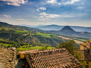 Houses at san leo village by mountains against sky