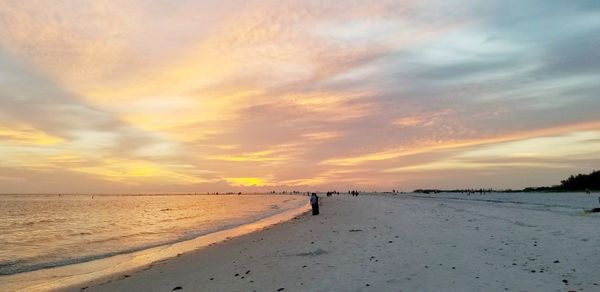 Scenic view of beach against sky during sunset