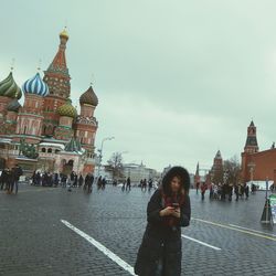 Woman standing in front of church