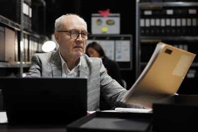 Young man using laptop at office