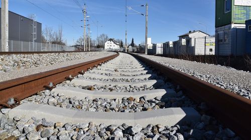 Surface level of railroad tracks against sky