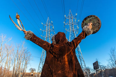 Low angle view of statue against clear blue sky