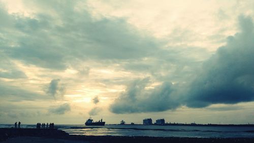 Scenic view of sea against cloudy sky
