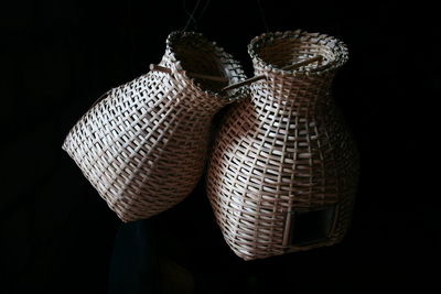 Close-up of wicker baskets over black background