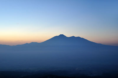 Scenic view of silhouette mount gede against sky during sunrise