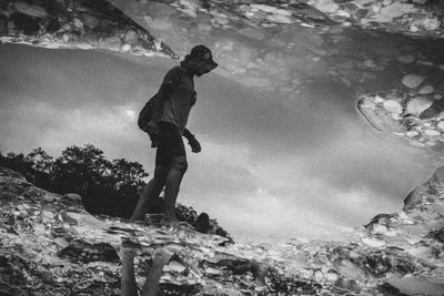 High angle view of woman reflecting in puddle