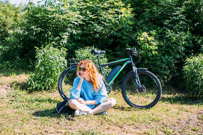 A young woman uses a modern electric bicycle for sports and outdoor recreation