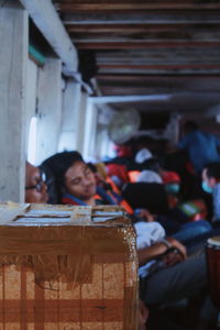 Portrait of man looking away while sitting on table