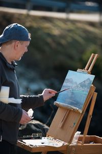 Man painting outdoors