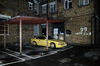 Cars on road by buildings in city