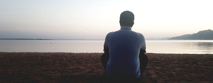 Rear view of man standing on beach