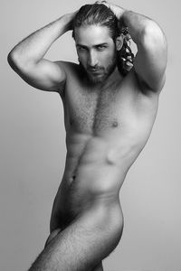 Portrait of naked handsome man against gray background