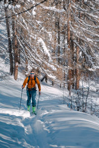 People skiing on snow covered landscape