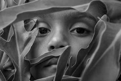 Close-up portrait of girl amidst plant