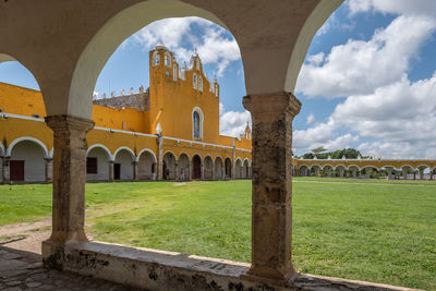 View through arch way to the church tower of monastery in izamal