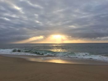 Scenic view of beach against sky during sunset