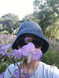 Close-up of woman with flowers on tree