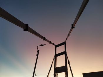 Low angle view of silhouette crane against sky during sunset