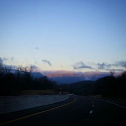 Country road leading towards mountains