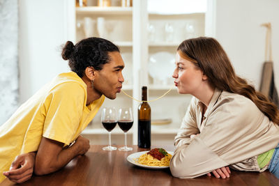 Female friends having food at home