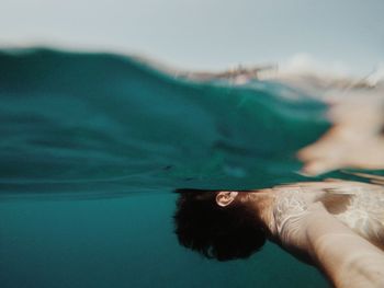 Close-up of man hand in sea