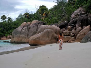 Scenic view of rocks on beach against sky