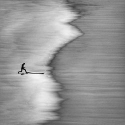 Silhouette man running on beach