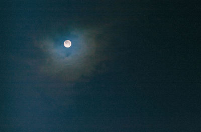 Low angle view of moon in sky at night