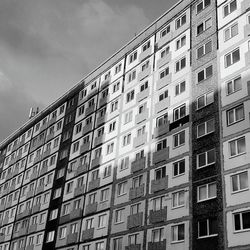 Low angle view of building against cloudy sky