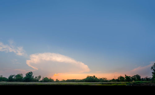 Scenic view of field against sky during sunset