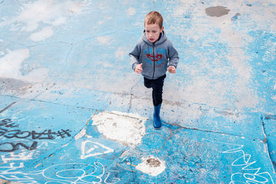 High angle view of boy standing in city