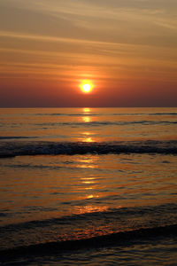 Scenic view of sea against romantic sky at sunset