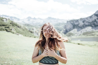 Happy woman standing on mountain