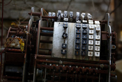 Close-up of old machine part on table