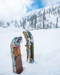 Built structure on snow covered field against sky