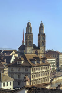 Buildings in city against clear sky