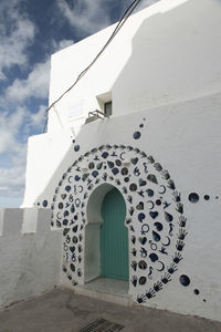 White door of building against sky