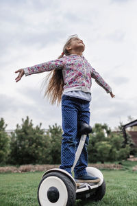 Girl standing on land against sky
