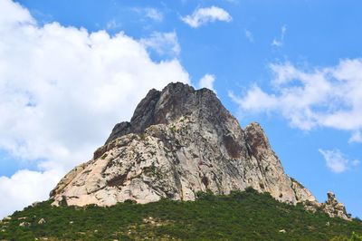 Low angle view of rock formations against sky