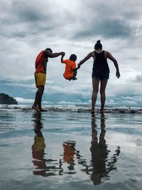 Man standing on beach against sky