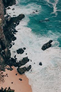 High angle view of rocks in sea