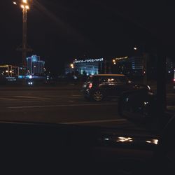 Cars on city street at night