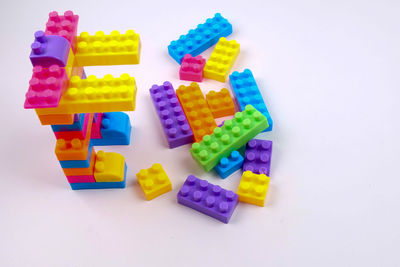 High angle view of colorful toys over white background